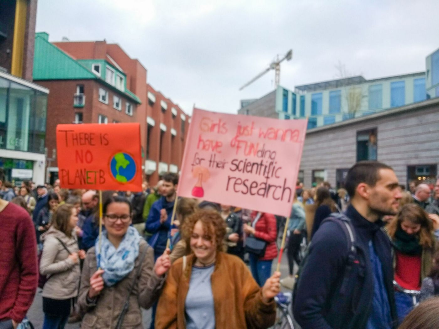 Eine Gruppe von Personen, die auf einer Demonstration auf die Bedeutung von Wissenschaft aufmerksam machen und Poster hoch halten. (Foto: WWU/Johannes Sträßer)