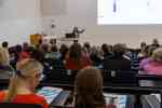 Eine Person steht an einem Rednerpult vor Publikum und spricht zum Plenum (Foto: FH Münster/Anna Thelen)