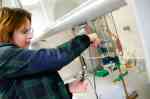 Svitlana prepares the electrochemical cell in the Laboratory for Applied Materials Science.